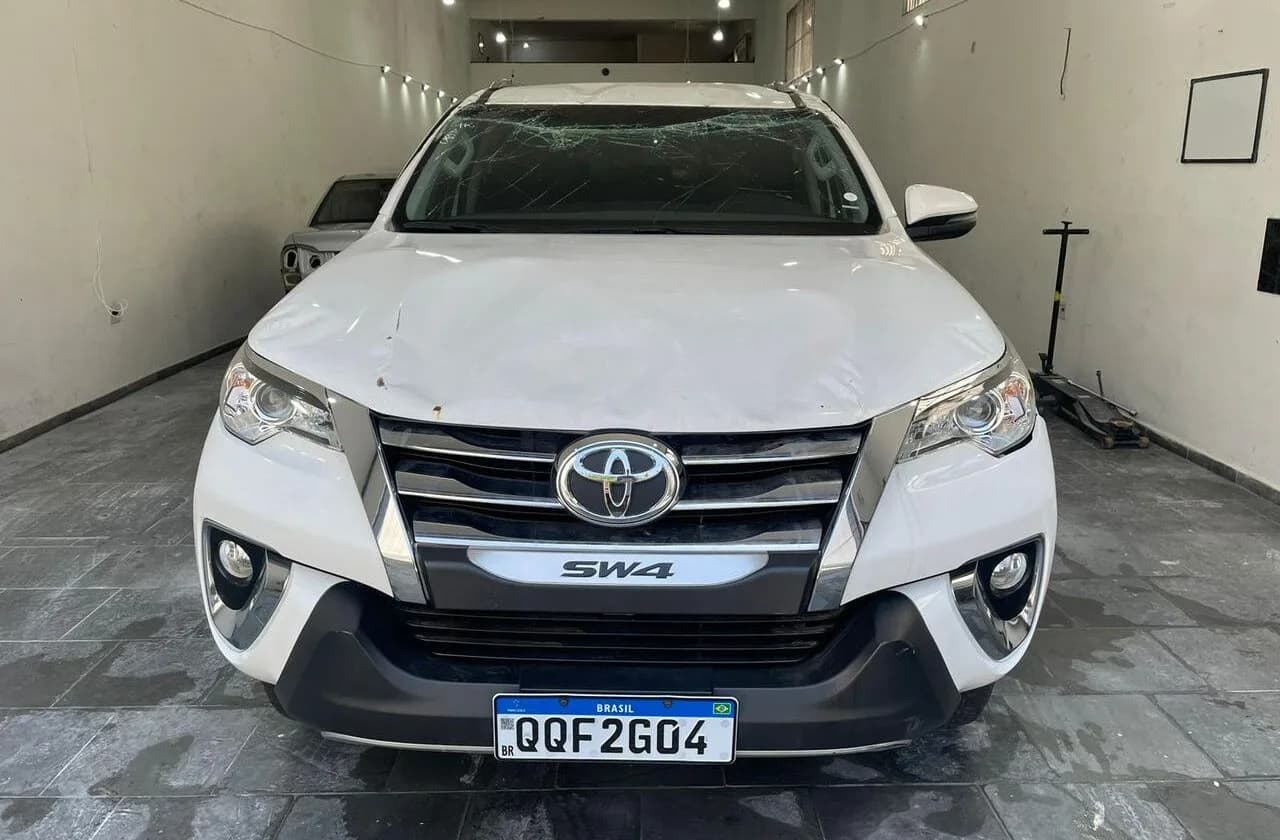 Toyota SW4 branca antes do reparo, com danos na frente